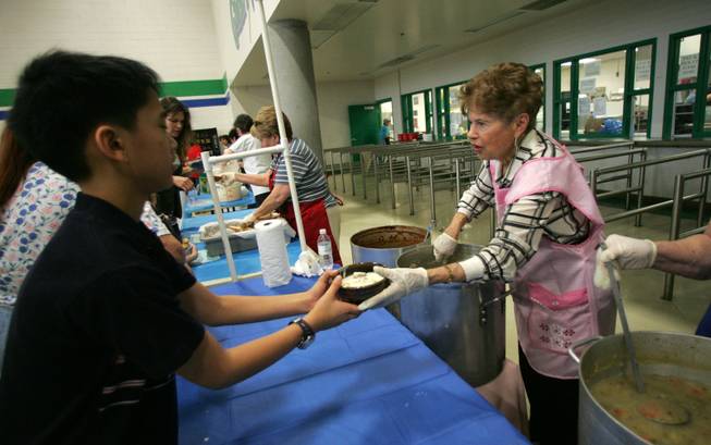 Volunteer Alma Strabala serves a bowl a soup to Matther Chen, 12, during the Empty Bowl benefit luncheon at Green Valley High Saturday, March 21, 2009. Money raised during the event will be used to feed the homeless of Las Vegas. 
