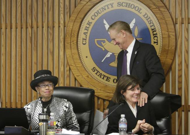 Clark County Schools Superintendent Walt Rulffes passes by board President Terri Janison and board member Linda Young, left, as he leaves Thursday's school board meeting. He announced at the meeting that he will retire in August when his contract expires.