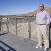 Sunrise Mountain High School football coach Jason Basso poses in front of the soon-to-be new football stadium.
