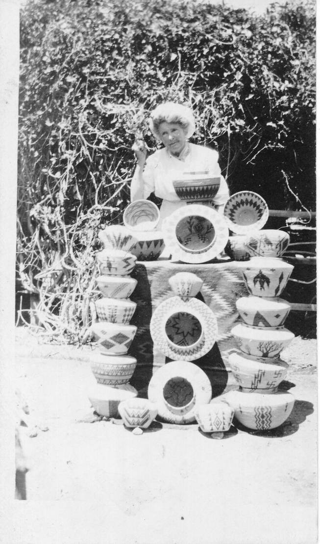 Helen J. Stewart, a Las Vegas pioneer, is shown here with part of her collection of decorative baskets produced by the Moapa Paiutes in the early part of the 20th Century.