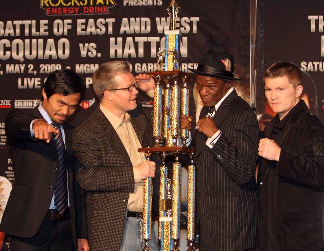 Boxers Manny Pacquiao, far left, of the Philippines, and Ricky Hatton, far right, of England, pose with their trainers Freddie Roach, center left, and Floyd Mayweather Sr., who lift a specialized trophy for the "No. 1 Pound for Pound Best Trainer in the World" during a news conference in Hollywood, California March 30, 2009. Hatton and Pacquiao will meet for a junior welterweight title fight at the MGM Grand Garden Arena in Las Vegas on May 2.