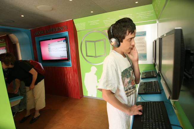 William Culberth, 13, explores the 74-foot, 18-wheel digital bookmobile on display April 2 in the parking lot of the Galleria at Sunset mall.
