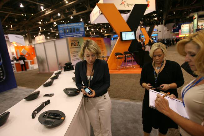 Motorola representative Kristi Lundgren gives a demonstration of Motorola's newest handset, the Evoke Q4A, on Thursday, the second day of the 2009 CTIA Wireless convention at the Las Vegas Convention Center.