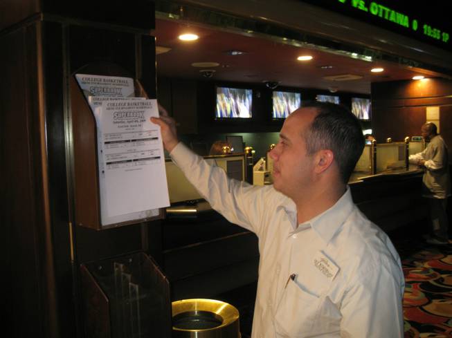 Jay Kornegay, pretending to study a betting sheet so I can take a photo of him.