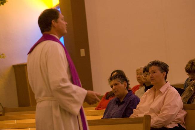Charlotte Morgan, right, and Julie Liebo, center, who have been partners for 19 years, listen to Sunday to Pastor Dave Krueger-Duncan, of the Northwest Community Church.