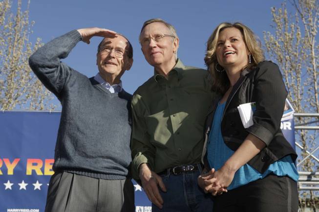 Senate Majority Leader Harry Reid is flanked by former U.S. Sen. Richard Bryan and Washoe County Commissioner Kitty Jung as he waits to speak to a rally at UNR in Reno on Tuesday.