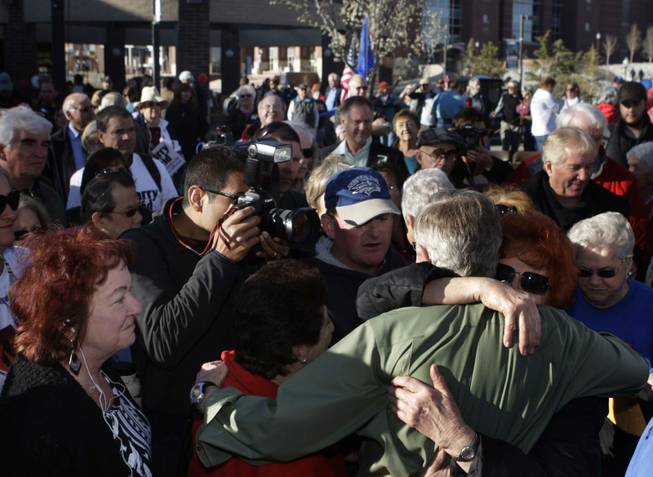Senate Majority Leader Harry Reid is is hugged by supporters after speaking at a rally at UNR in Reno on Tuesday/