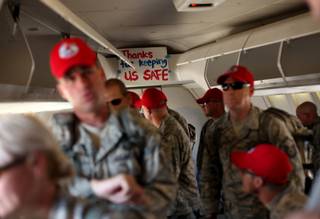 A group of airman get off a plane as they return home on April 6 to Nellis Air Force Base. They are among 290 members of the 820th RED HORSE Squadron who spent six month deployed to Iraq and Afghanistan.