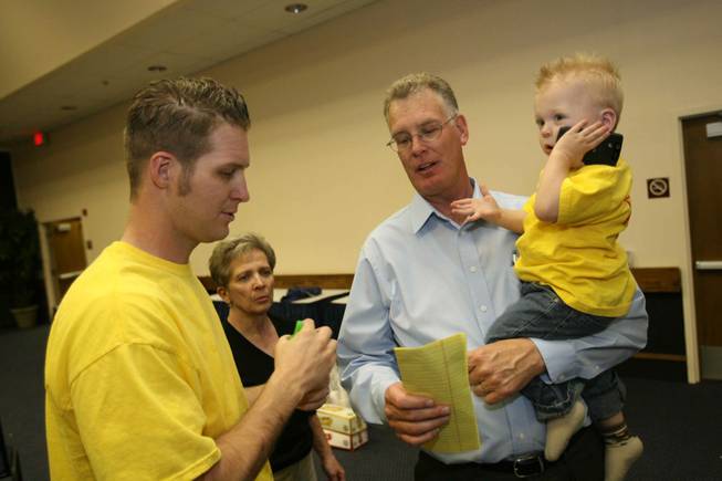 Henderson mayoral candidate Andy Hafen holds his grandson, Logan, as he talks to his son Andrew about election results Tuesday during his campaign's party at the Henderson Convention Center.