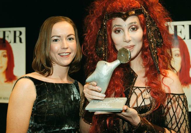 American singer-actress Cher is presented the Music Control Airplay Award (MCAW) by Victoria van Loan, left, Wednesday Nov. 17, 1999, during a ceremony in Stockholm Globe concert hall. Cher is the only artist this year to have two songs in the top 10 for the accumulated year. Music Control is an organization that monitors both public and commercial radio stations in order to publish the indispensable Airplay Top 100 chart each week. 
