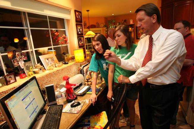 Henderson mayoral candidate Steve Kirk, right, keeps an eye on the election results with his daughters Stacie, center, and Jennifer during his campaign's results party Tuesday. 