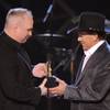 Garth Brooks, left, presents George Strait with the Artist of the Decade award at the ACM Artist of 
