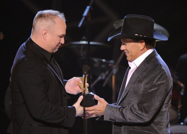 Garth Brooks, left, presents George Strait with the Artist of the Decade award at the ACM Artist of the Decade All Star Concert on Monday, April 6, 2009, in Las Vegas. 