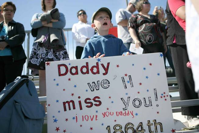 Austin Gibson, 6, holds up a farewell sign for his father, Sgt. Sean Gibson, during a mobilization ceremony for the 1864th Transportation Company Thursday at the Nevada Army National Guard Floyd Edsall Training Center.