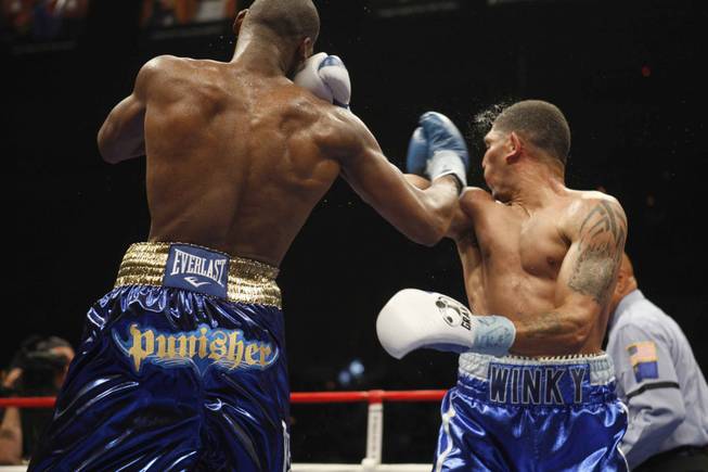Winky Wright (right) takes a punch from Paul Williams Saturday night at Mandalay Bay Events Center.