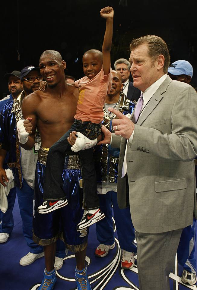 Paul Williams celebrates with his son Paul Williams Jr., 6, and boxing promoter Dan Goossen after defeating Winky Wright in a middleweight fight at the Mandalay Bay Event Center in Las Vegas, Nevada on April 11, 2009.