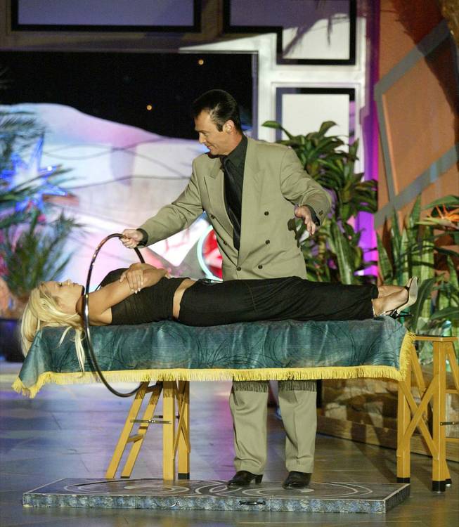Lance Burton performs a magic trick with Pamela Anderson during a taping of "The Tonight Show with Jay Leno" in Las Vegas, Tuesday, May 11, 2004.
