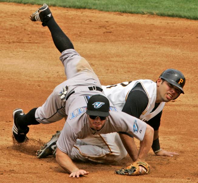 Pittsburgh Pirates' Raul Chavez, right, upends Toronto Blue Jays second baseman Joe Inglett after a force out in fourth inning of a baseball game at Pittsburgh Sunday, June 22, 2008.