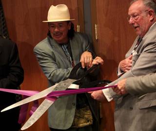 Carlos Santana (left) and Las Vegas Mayor Oscar Goodman cut the ribbon as Hard Rock Hotel & Casino held a ceremony Tuesday to celebrate the completion of The Joint, the Hotel's new concert venue.

