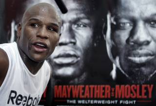 Undefeated boxer Floyd Mayweather Jr. works out at his gym Wednesday. In the background is a poster promoting his upcoming fight against WBA welterweight champion Shane Mosley. Mayweather will fight Mosley for the title at the MGM Grand Garden Arena on May 1.