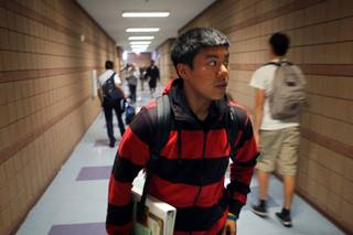 Marlon Magsaysay, a student in the AVID program, makes his way through a hallway at Liberty High School Wednesday, April 15, 2009. The budget cuts are hitting hard at Liberty High. The school will lose 14 teachers, the popular block schedule and the AVID tutoring program. Principal Rosalind Gibson said the school expected to lose a few teachers because of enrollment declines since the campus was built to serve neighborhoods that either never got built or are now largely vacant. But she wasn't prepared for just how deep the cuts would go. 