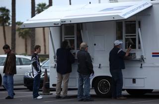 A line forms outside the mobile Post Office stations set up in the Mandalay Bay parking lot on Wednesday. This is the seventh year that Mandalay Bay has offered free ticket vouchers to the Shark Reef Aquarium for those who file tax returns from the site.