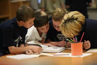 Vanderburg Elementary School fourth graders, from left, Trey Hulburt, 9, Jeffrey Downer, 10 Alex Sigman, 10, and Cody Butler, 10, gather research for a project put on by GATE instructor William Gilluly Friday.