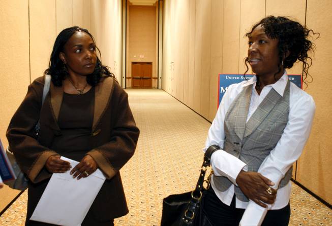 Roxann McCoy, left, a mortgage broker, and Gwen Braimoh, owner of Expertise Cosmetology Institute, talk during a seminar designed to help Nevadans take advantage of stimulus funding at the Mandalay Bay Thursday. 