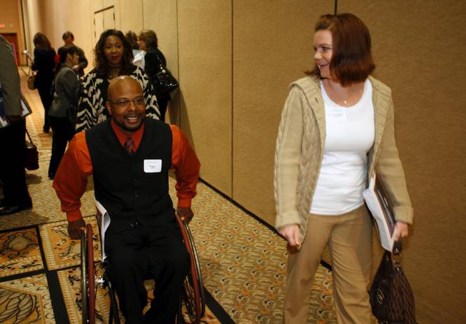 Reggie Bennett and Cheyenne Holcomb attend a seminar designed to help Nevadans take advantage of stimulus funding at the Mandalay Bay Thursday. 