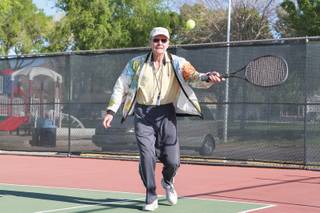 Fred Donaldson, 80, hits a forehand down the line playing doubles with the tennis club at Broadbent Park in Boulder City.