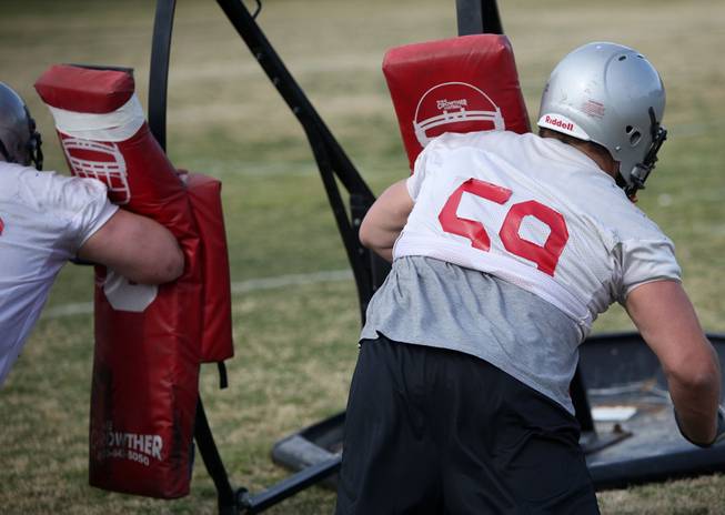 UNLV senior guard Joe Hawley (59) works a blocking sled during spring practice. Hawley is one of four returning starters on an offensive line that allowed only 14 sacks in 12 games a year ago.