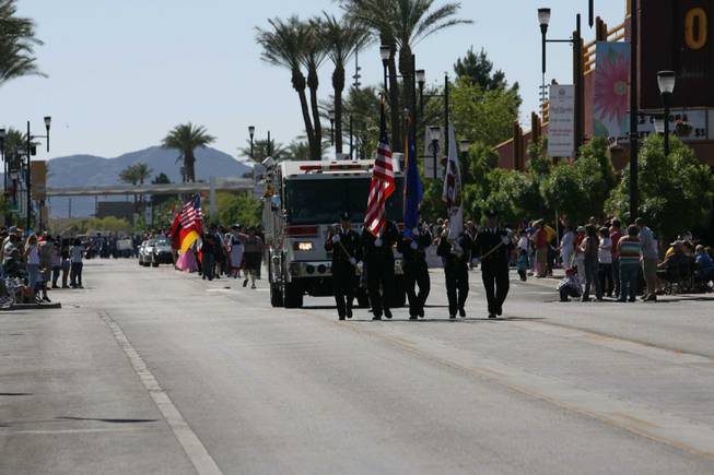 Members of the Henderson Fire Department pass the crowd during Henderson's annual Heritage Parade on Water Street.
