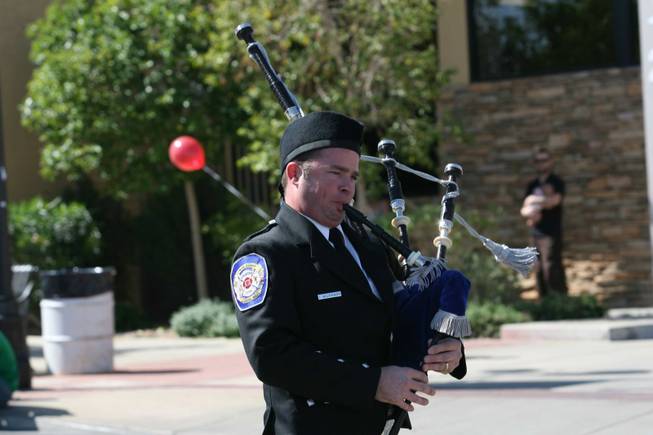 A member of the Henderson Fire Department Honor Guard blows the bag pipes during Henderson's annual Heritage Parade on Water Street.