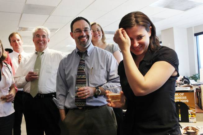 Editorial writers, David Clayton, from left, and Matt Hufman, share in remarks and champagne with reporter Alexandra Berzon on Monday in celebration of the Las Vegas Sun winning the Pulitzer Prize for public service for exposing a high death rate among construction workers on the Las Vegas Strip, at the Las Vegas Sun offices.