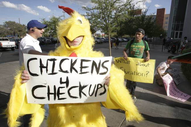 A man in a chicken costume pickets before a UNLV College Republicans event at UNLV on Tuesday, April 20, 2010. The protest was in reference to U.S. Senate candidate Sue Lowden's suggestion that patients barter with their doctors for health care. The College Republicans endorsed Lowden at the event.