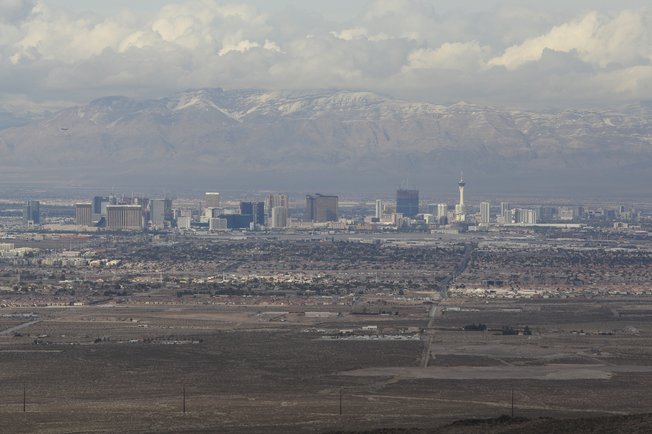This photograph from December 2008 shows a view of the Las Vegas Strip from the Sloan Canyon National Conservation Area. Nearby, two mining companies are seeking approval from the Bureau of Land Management to start a 640-acre rock-excavation operation, agitating Henderson residents concerned about dust and noise.