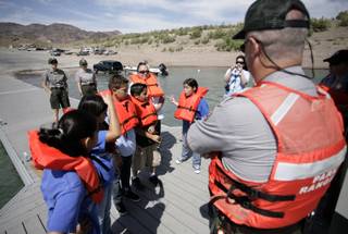 Fifth-grade students from Sandy Searles Miller Elementary School receive instruction on Thursday from Ranger Dave Horne during their participation in Lake Mead National Recreation Area's C.R.E.W. program (Citizens Removing and Eliminating Waste).