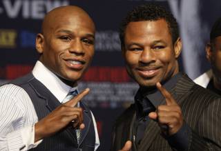 Undefeated welterweight boxer Floyd Mayweather Jr., left, and WBA welterweight champion Shane Mosley pose during a news conference at the MGM Grand Wednesday, April 28, 2010. The fighters will meet for a welterweight bout at the MGM Grand Garden Arena Saturday.