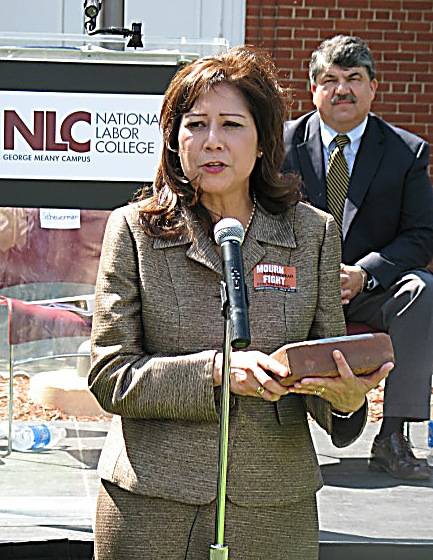 Secretary of Labor Hilda Solis dedicates a brick for Department of Labor employees who died in service as Richard L. Trumka, Secretary Treasurer of the AFL-CIO, looks on. Memorial bricks, inscribed with the names of workers who lost their lives on the job, are displayed during the groundbreaking ceremony for the new National Workers Memorial