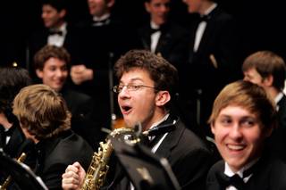 Tenor saxophone player Steven Porter reacts to the news that the Green Valley High School Symphonic Band was chosen to play in the 2010 Macy's Thanksgiving Day Parade during their Spring Music Concert at the Henderson Pavilion on Wednesday.