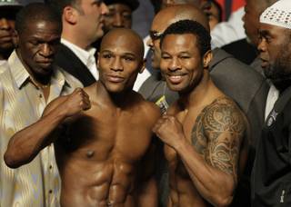 Undefeated welterweight boxer Floyd Mayweather Jr., left, and WBA welterweight champion Shane Mosley pose during an official weigh-in at the MGM Grand Garden Arena Friday April 30, 2010. The fighters will meet for a welterweight bout at the arena Saturday. 