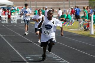 Troy Smith of Mack Middle School leans into the finish line of the 50-meter run Friday during the Special Olympics School Games at Western High School.