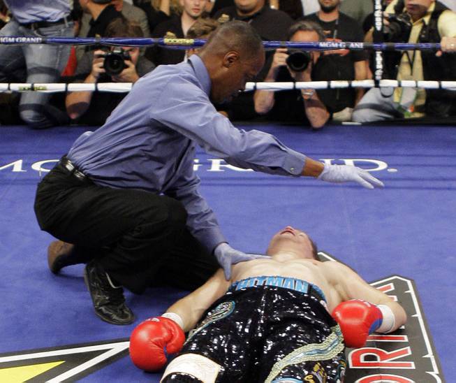 Referee Kenny Bayless checks on British boxer Ricky Hatton after he was knocked out by Manny Pacquiao, of the Philippines, in the second round of their junior welterweight title boxing match Saturday, May 2, 2009, at the MGM Grand in Las Vegas.