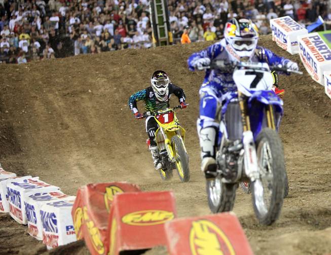 James Stewart (7) and Chad Reed battle for the 2009 Monster Energy AMA Supercross, an FIM World Championship, at the season finale at Sam Boyd Stadium on Saturday in Las Vegas.