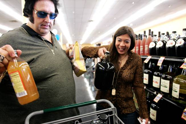 Pete Vallee buys wine at Sunflower Market with his girlfriend Amanda Lasham on Saturday, May 2, 2009. Vallee drinks a glass of red wine with dinner every night for his heart.