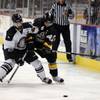 Wranglers defenseman Mike Madill (9) battles Thunder center Craig Valette for the puck during the first period of action at the Orleans on May 4.