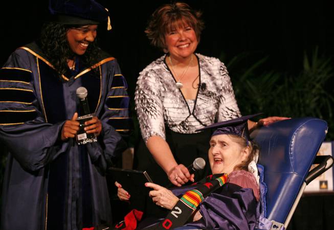 Shelia Silverstein (right) reacts as she is given a diploma by Dr. Sandra Owens Kane. In the background is Laurie Labishak from Second Wind Dreams.