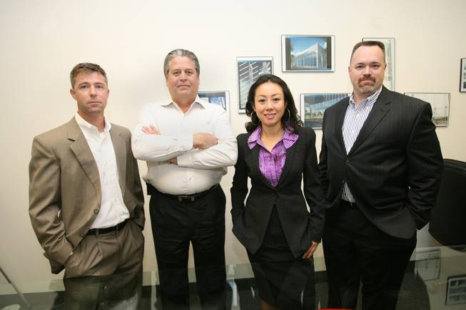 Zetian System Inc. CEO Weina Zhang, center right, and company president Greg Olin, second left, pose with Z Glass Inc. President Steve Miller, left, and vice president Anthony Taylor.