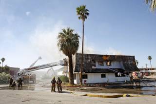 Firefighters work to control a blaze in an apartment building at the old Moulin Rouge hotel and casino on Bonanza Road. The apartments were supposed to have been vacant were destined to be torn down, officials said.