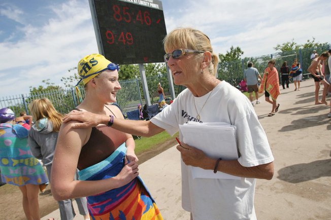 Boulder City senior Caiti Forrester, left, gets some words of encouragement from coach Sara Carroll during a swimming meet at the Henderson Multi-Generational Pool on Saturday.
